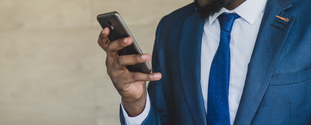 Business man looking at smart phone