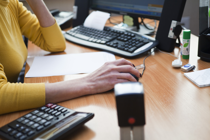 Close up of a woman using a computer mouseClose up of a woman using a computer mouse