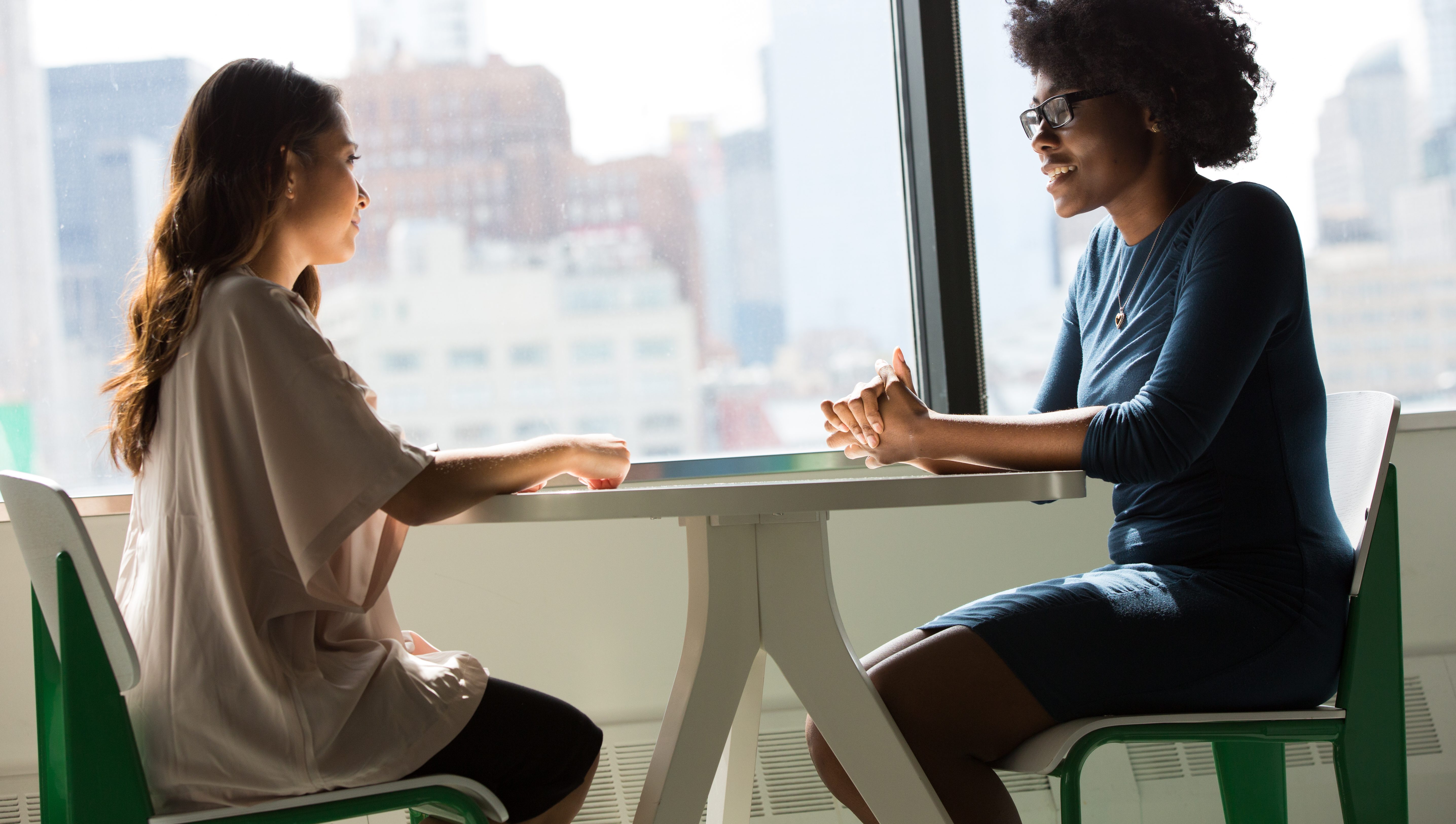 Two women sitting at a table talking