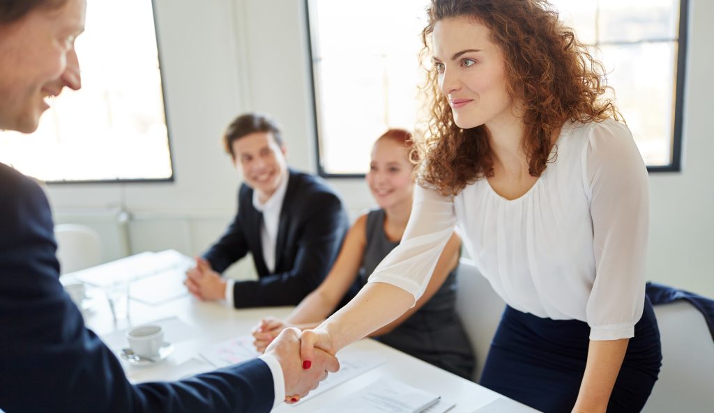 Woman shaking the hand of a new colleague