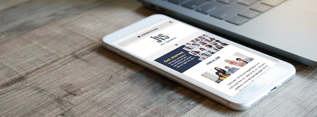 Smart phone and laptop displaying JVS Toronto's web site.