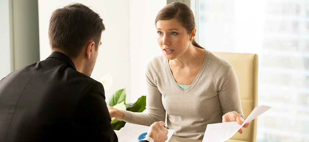 Angry businesswoman arguing with businessman about paperwork fai