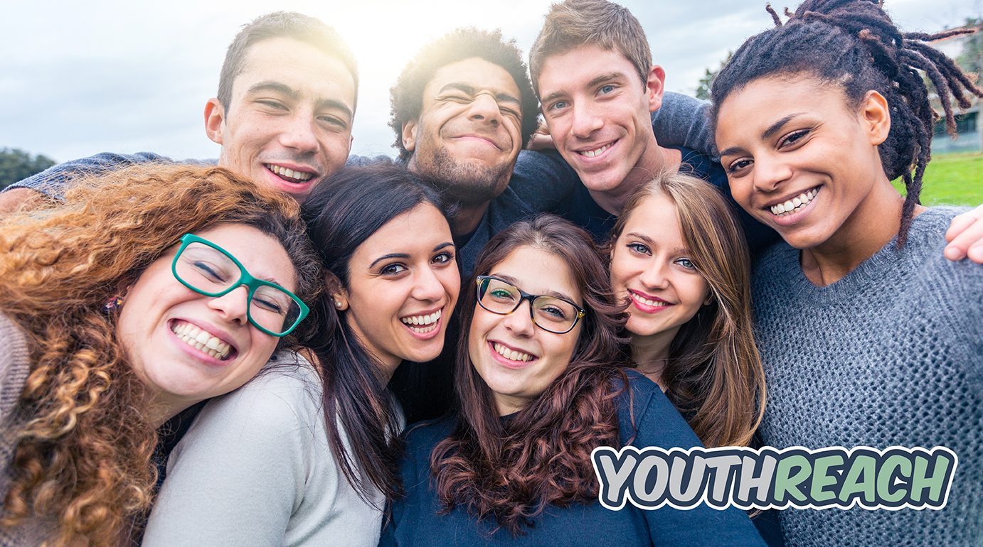 Group of friends with mixed races having fun together at park