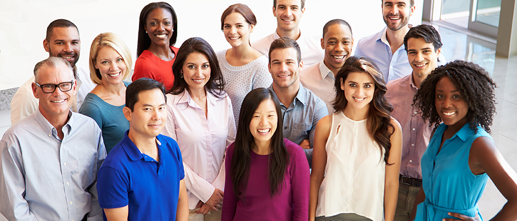 Portrait Of Multi-Cultural Office Staff Standing In Lobby